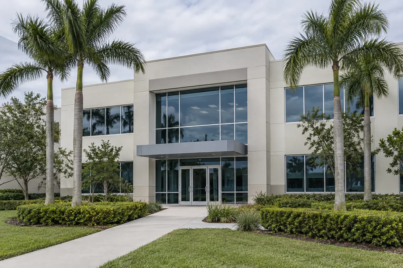 Illustrative commercial property with palms and a glass entrance