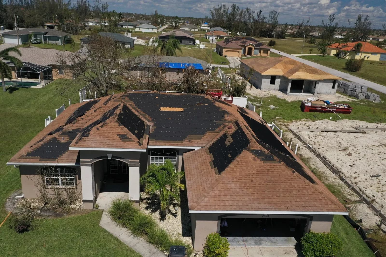 Aerial photograph of roof damage after a hurricane
